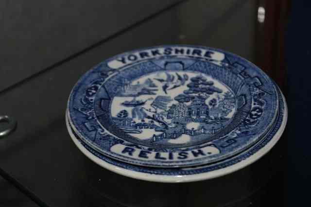 Appraisal: A SMALL YORKSHIRE RELISH DISH inscribed 'Thick or Thin' beneath