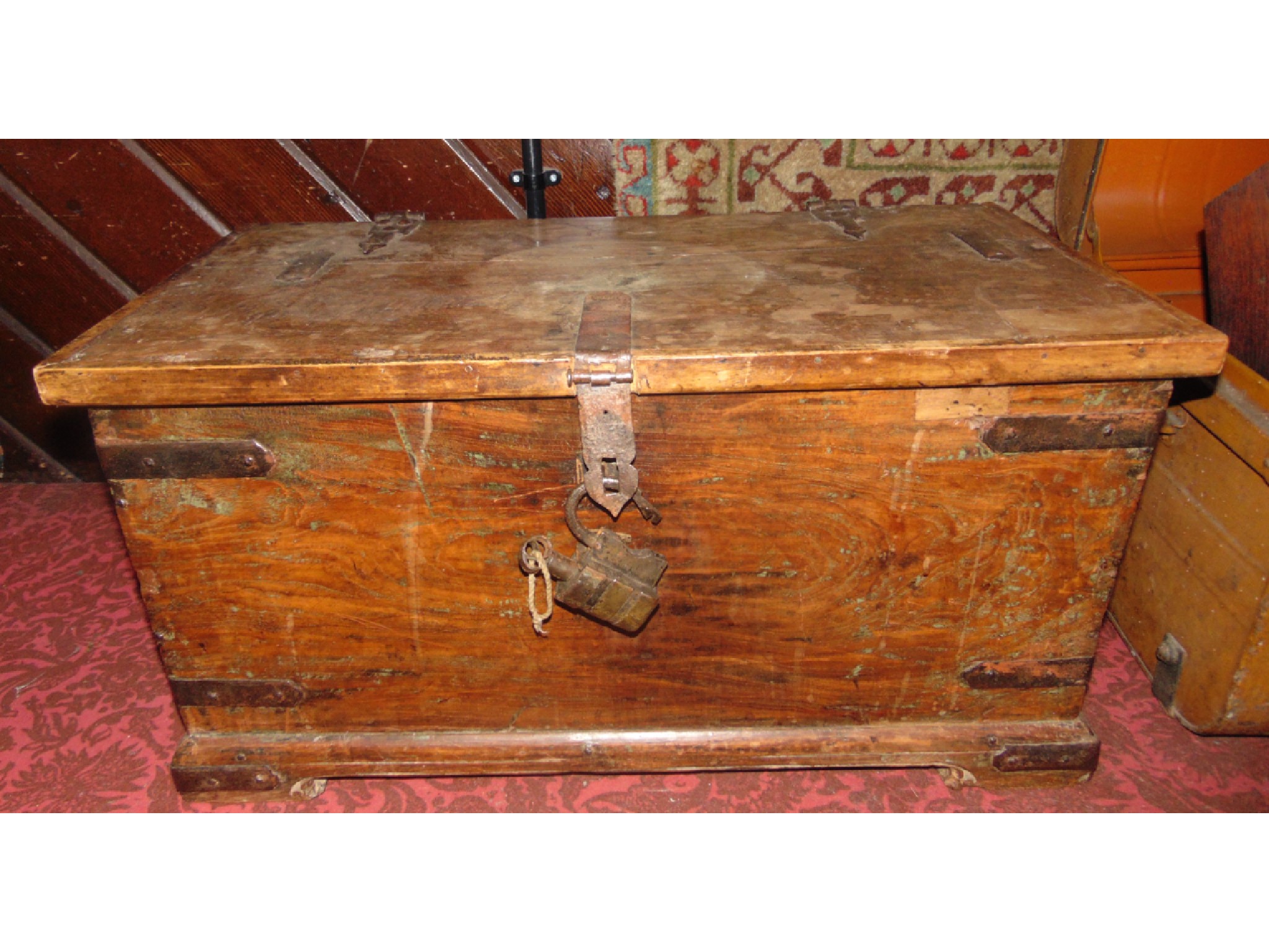 Appraisal: An old eastern timber coffer with iron banded detail and