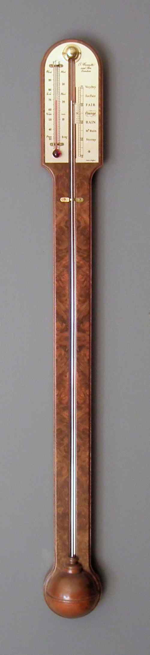 Appraisal: A modern burr walnut stick barometer with engraved brass scale