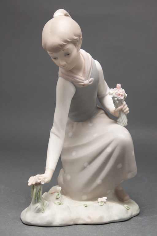 Appraisal: Lladro bisque porcelain figure of a young girl gathering flowers