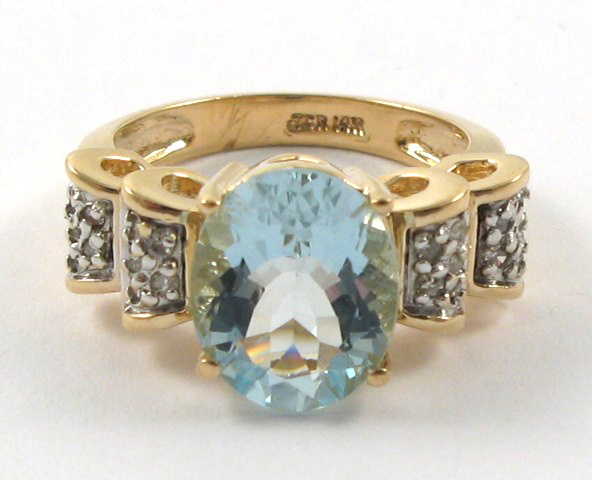 Appraisal: AQUAMARINE AND DIAMOND RING k yellow gold centering an oval-cut