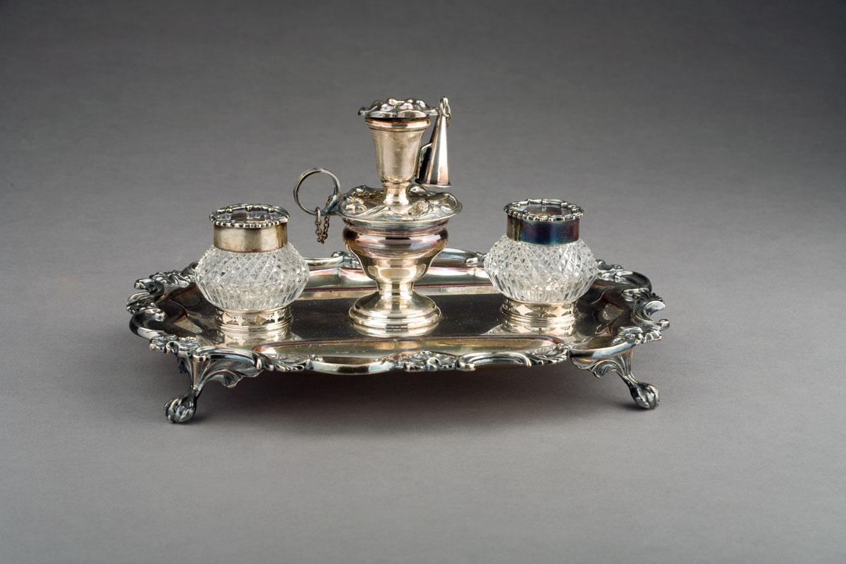 Appraisal: ENGLISH SILVERPLATE AND CRYSTAL INKWELL WITH CANDLE HOLDER AND SNUFFER