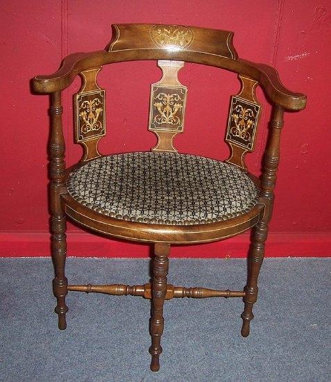 Appraisal: An Edwardian oval seat armchair inlaid cornucopia and basket of