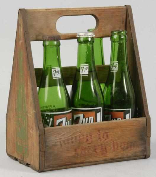 Appraisal: Wooden up Carrier with Bottles Description s Comes with four