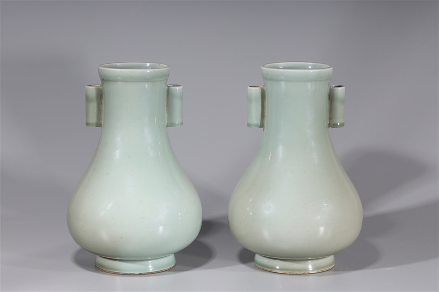 Appraisal: Pair of celadon vases each with scrolling handle on neck