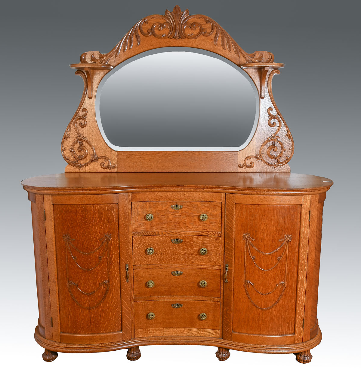 Appraisal: TIGER OAK MIRRORED CREDENZA Kidney shaped drawer door credenza Surmounted