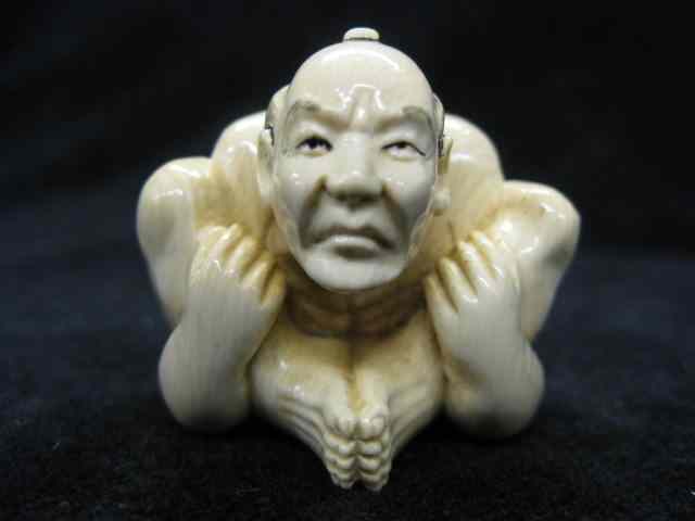 Appraisal: Carved Ivory Netsuke of a Seated Man balled-up fancy polychrome