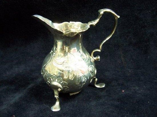 Appraisal: A George III baluster cream jug of rocaille repouss design