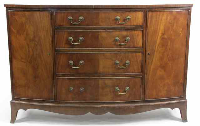 Appraisal: A mahogany bowfront sideboard fitted four drawers and two cupboards