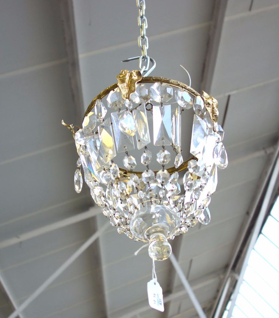 Appraisal: A three tier brass and cut glass bag chandelier th