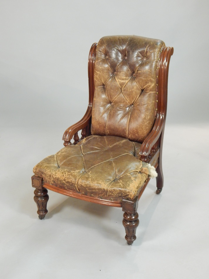 Appraisal: A Victorian walnut nursing type chair with distressed brown leather