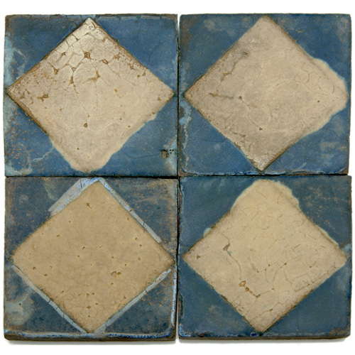 Appraisal: GRUEBY Thirty-one geometric tiles with a raised diamond pattern in