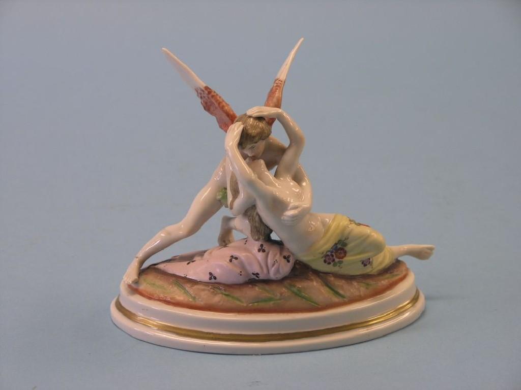 Appraisal: A Naples porcelain figure group female embracing winged angel printed