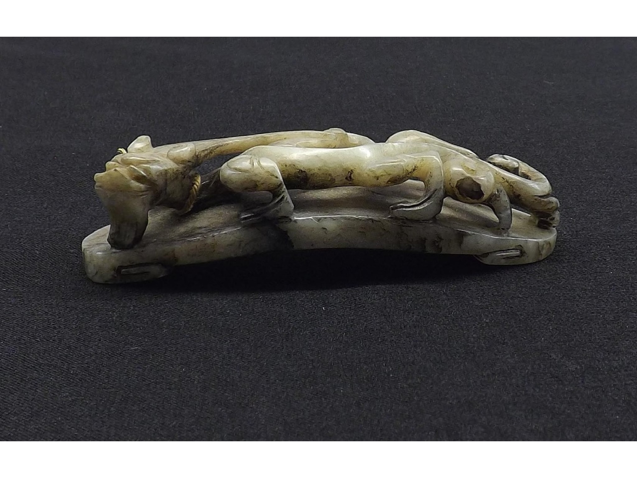 Appraisal: Celadon and dark veined carved jade modelled as a dragon