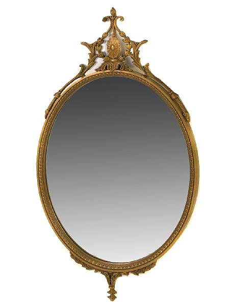 Appraisal: A pair of Neoclassical style oval giltwood mirrors together one