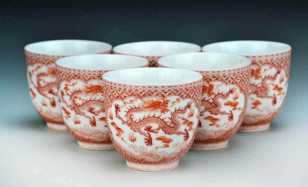 Appraisal: Chinese Iron Red Porcelain Tea CupsFinely painted in two panels