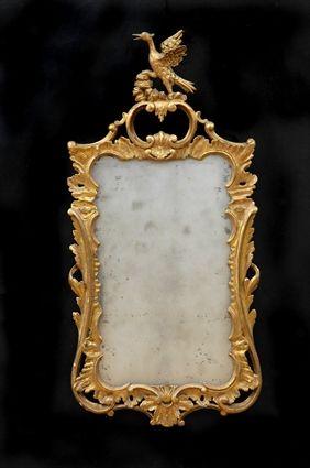 Appraisal: CHIPPENDALE-STYLE CARVED GILTWOOD MIRROR The pierced frame with flame cabochons