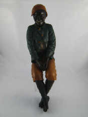 Appraisal: A painted figure of a black boy dressed as a