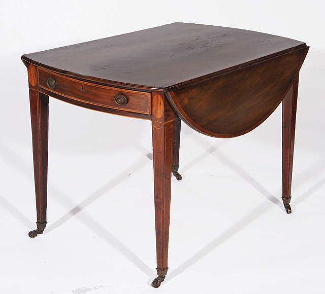 Appraisal: A GEORGE III MAHOGANY AND CROSSBANDED OVAL PEMBROKE TABLE fitted