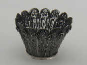 Appraisal: A silver filigree cachepot the foliage like panels with small