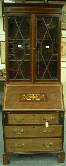 Appraisal: An early th Century mahogany bureau bookcase enclosed by a