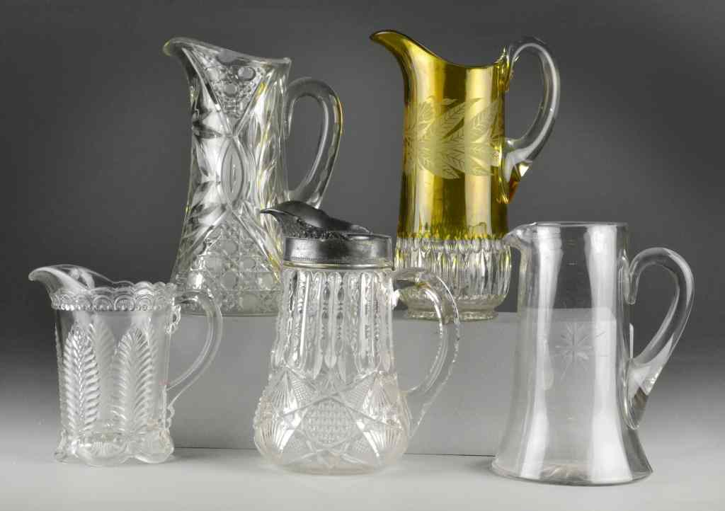 Appraisal: Glass PitchersCut glass pressed glass and amber glass pitchers largest