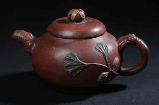 Appraisal: CHINESE YIXING TEA POT Impressed maker's mark applied foliate decoration