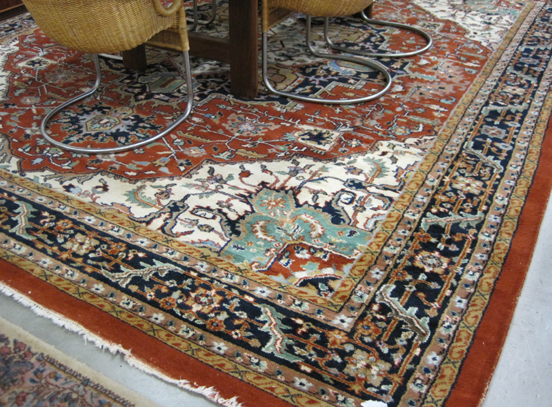 Appraisal: HAND KNOTTED ORIENTAL CARPET Indo-Heriz central medallion and stylized floral