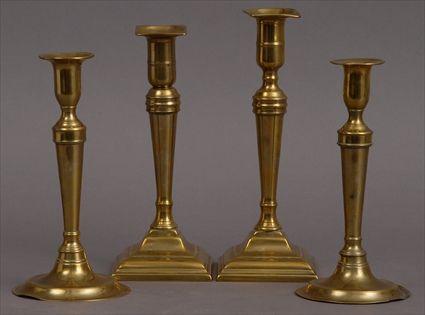 Appraisal: TWO PAIRS OF ENGLISH BRASS TABLE CANDLESTICKS Each tapered stem