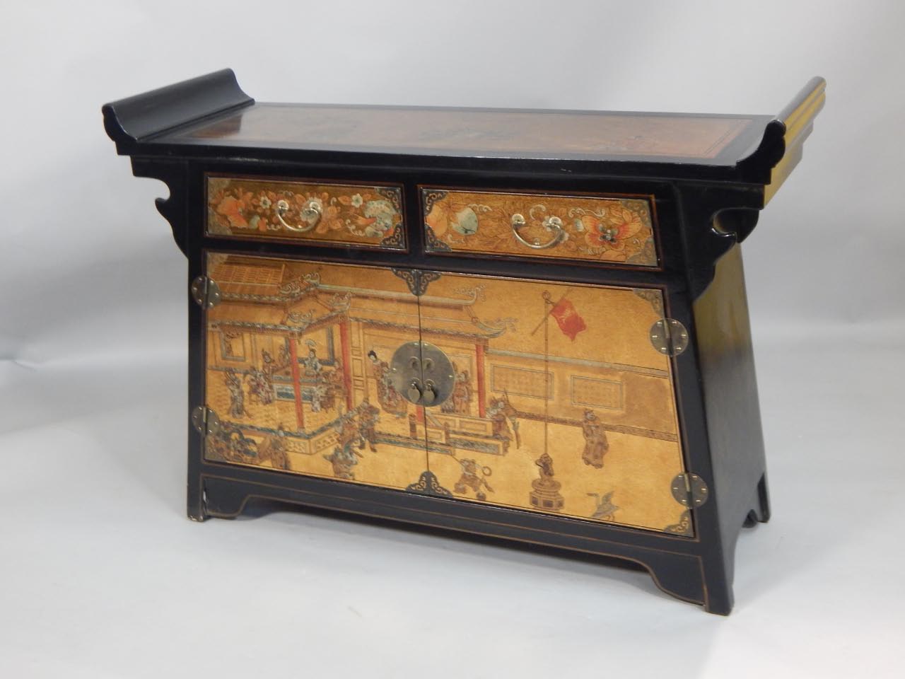 Appraisal: A modern oriental ebonised side cabinet decorated with figures buildings