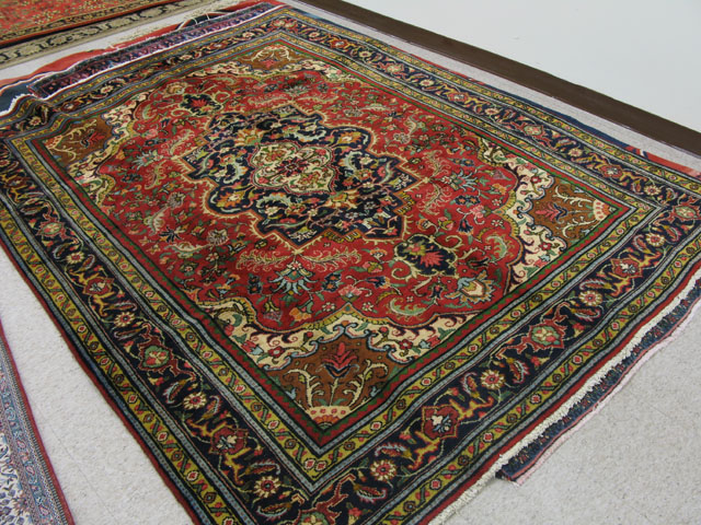 Appraisal: PERSIAN HERIZ CARPET floral and central flower-filled panel medallion on