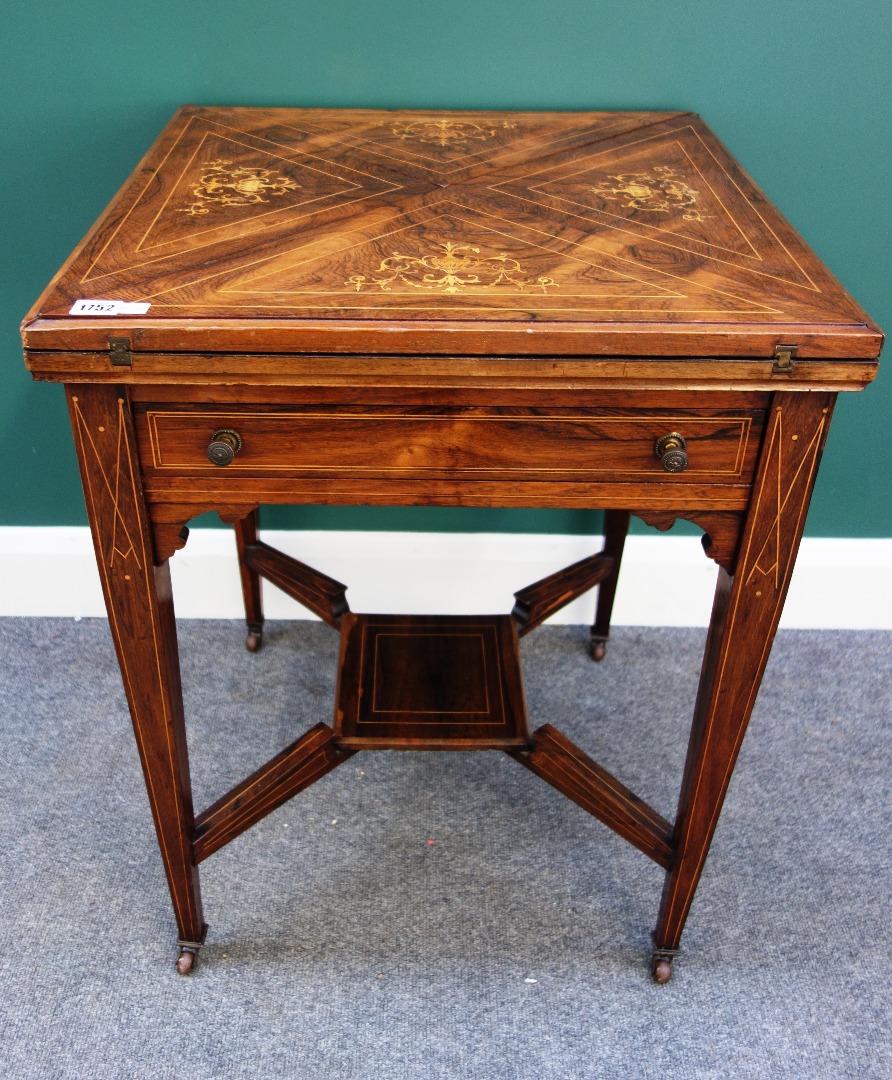 Appraisal: A late Victorian marquetry inlaid rosewood envelope card table with