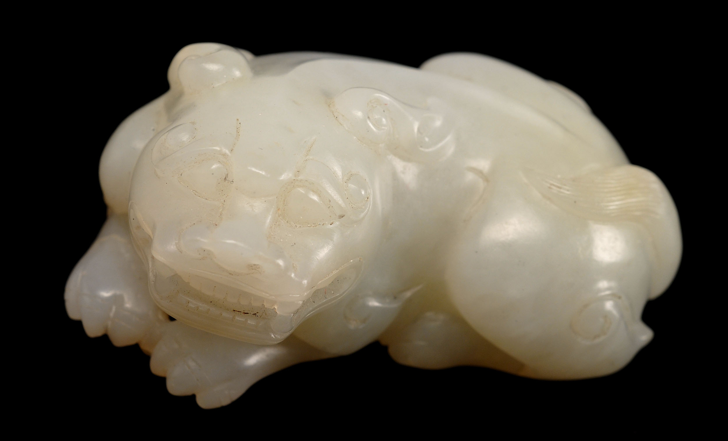 Appraisal: WHITE JADE FINGERING PIECE In the form of a reclining