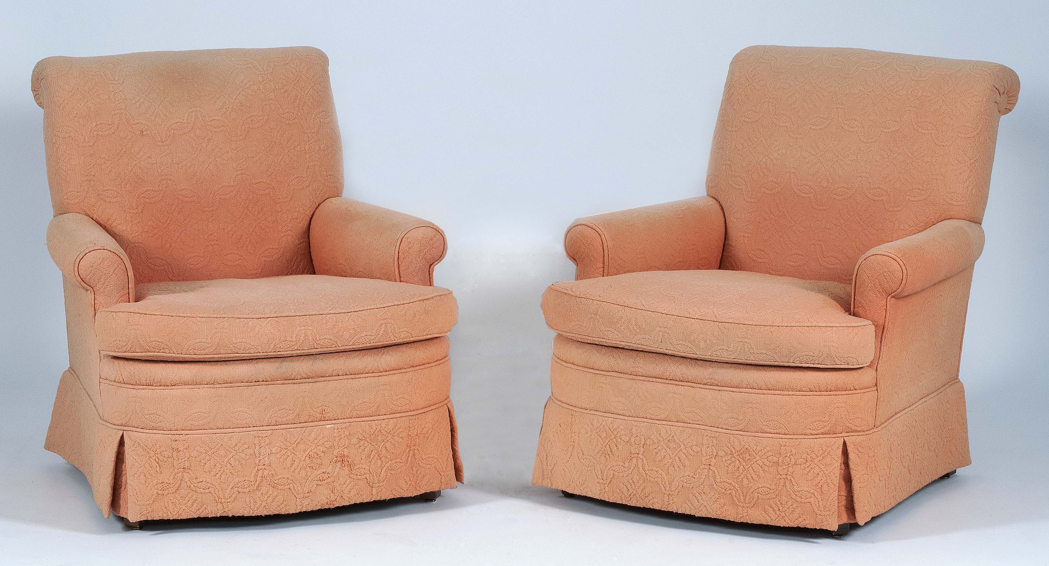 Appraisal: PAIR OF OVERSTUFFED ARMCHAIRS In matching coral upholstery Heights of