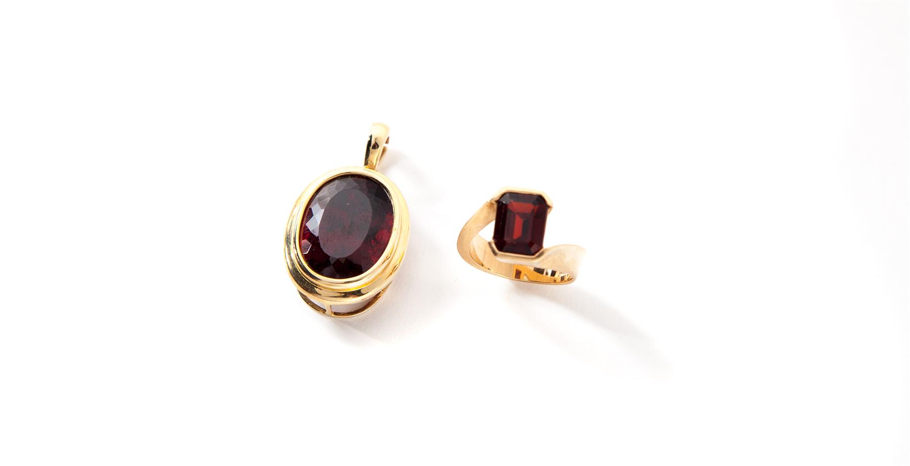 Appraisal: GARNET PENDANT AND RING American st century KYG enhancer pendant