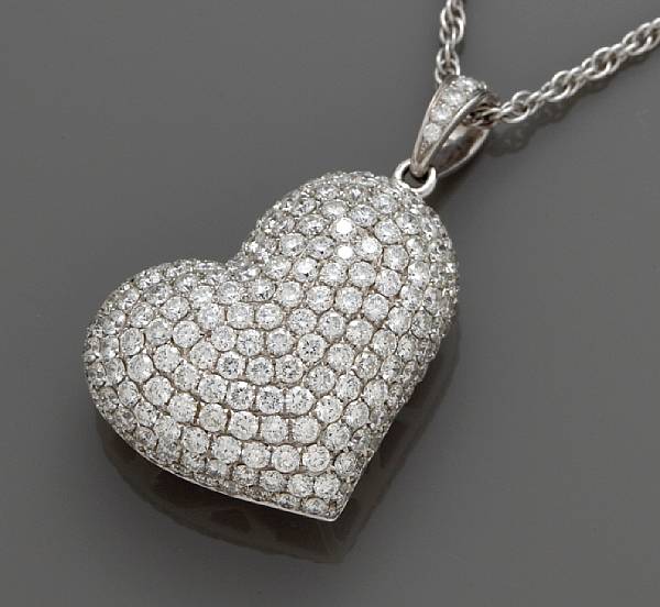 Appraisal: A diamond puffed heart pendant with chain estimated total diamond