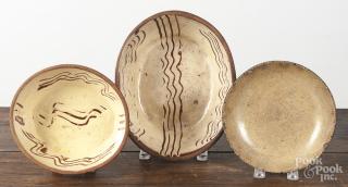 Appraisal: Two English redware baking dishes together with a shallow bowl