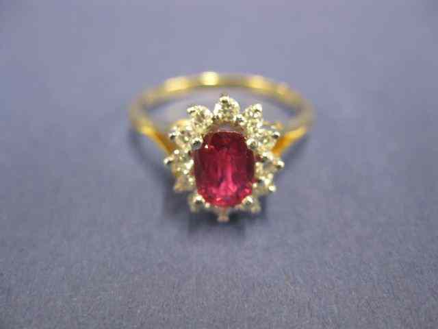 Appraisal: Ruby Diamond Ring carat oval gemsurrounded by diamonds totaling carat