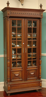 Appraisal: A LARGE GLAZED FRONT CONTINENTAL WALNUT TWO DOOR DISPLAY CABINET