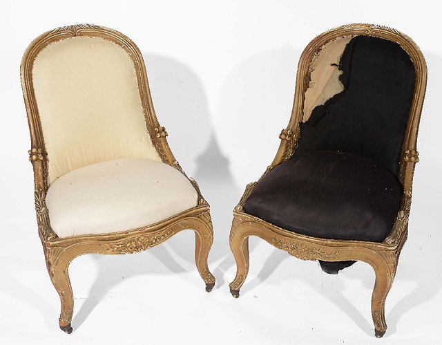 Appraisal: A pair of English giltwood low bergere chairsin the manner