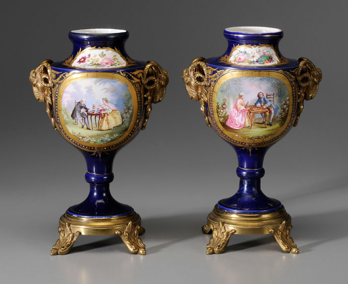 Appraisal: Pair S vres Urns French th century hand-painted scenes with