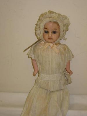 Appraisal: A wax over composition shoulder head doll with fixed blue