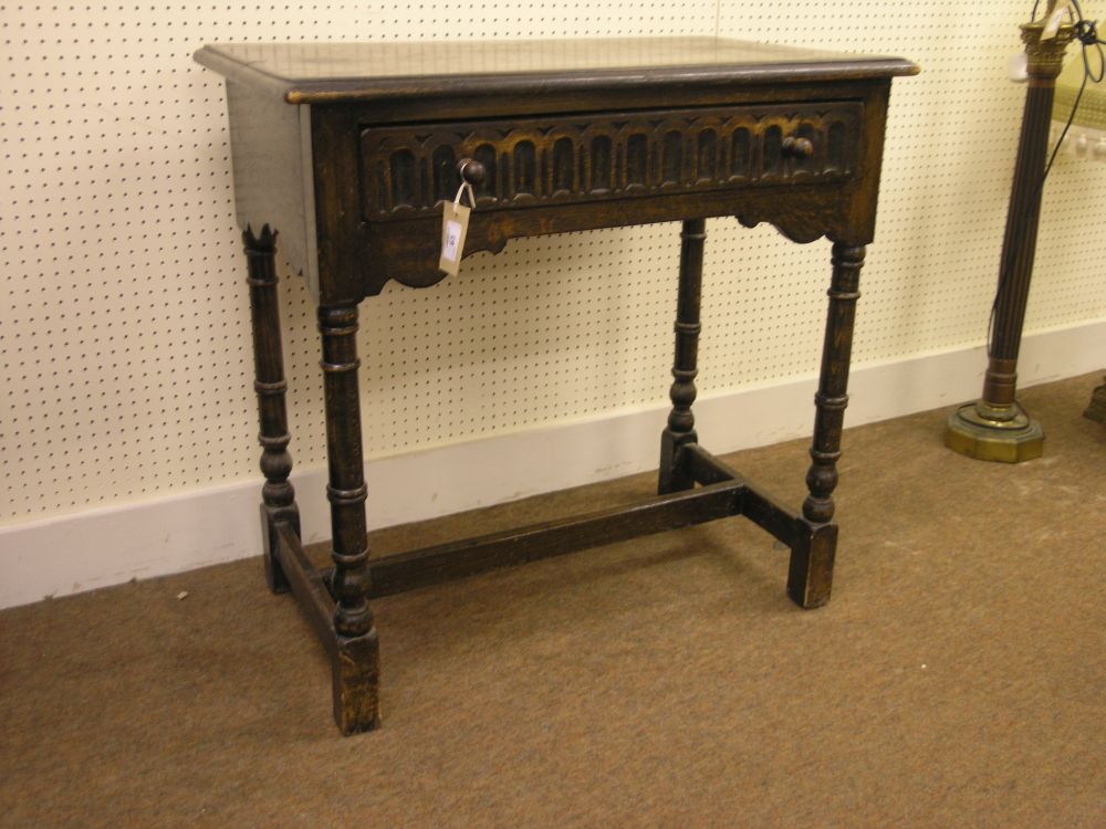 Appraisal: A solid dark oak side table with single frieze drawer