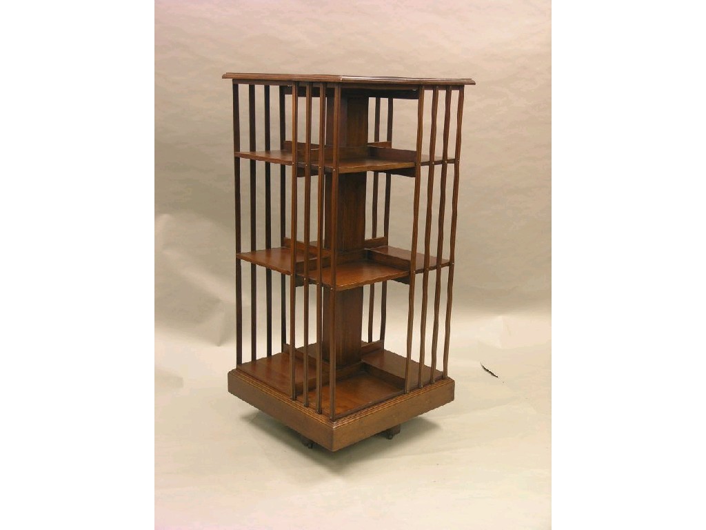 Appraisal: An Edwardian solid walnut three-tiered revolving bookcase with slatted divisions