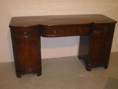 Appraisal: A VICTORIAN MAHOGANY PEDESTAL SIDEBOARD the bowed central section with