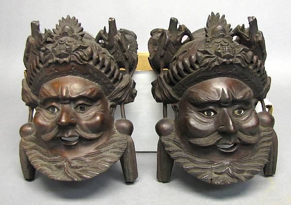 Appraisal: A pair of Chinese style wood masks Possibly depicting theatrical