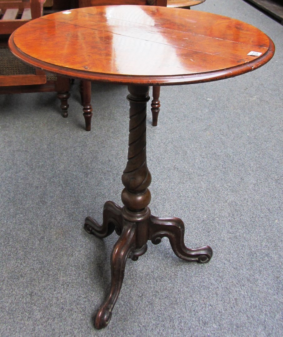 Appraisal: A Victorian figured walnut oval drop flap occasional table on