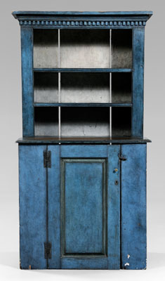 Appraisal: Blue-painted step back cupboard dentil-molded cornice paneled door opening to