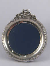 Appraisal: A circular photo frame with ribbon cresting replaced card strut