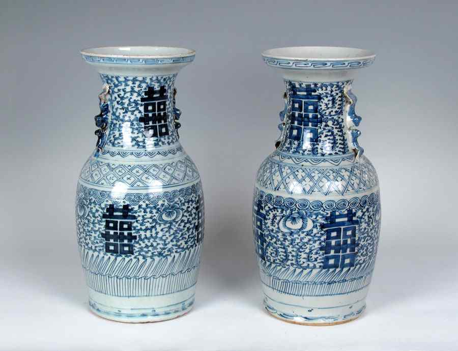 Appraisal: PAIR OF BLUE AND WHITE VASES Foliate floral and geometric